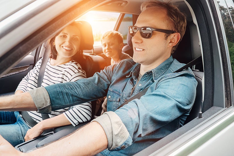 Family happily riding in car together